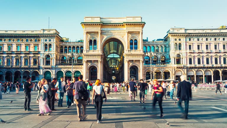 Time lapse of Crowded people tourist walking around Piazza del Duomo Milano and shopping fashion brand name product in Galleria Vittorio Emanuele II at Piazza del Duomo in Milan, Italy