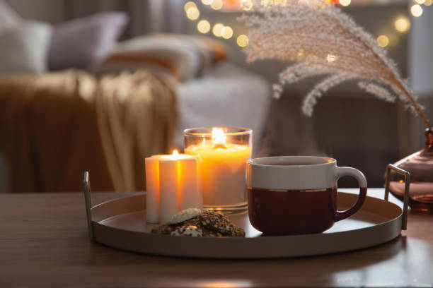 istock cup of tea with burning candles in cozy home 1830555596