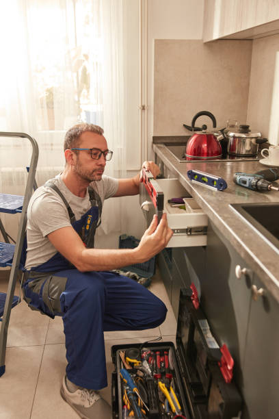 istock Handyman fixing kitchen cabinets in the apartment. 1830555852