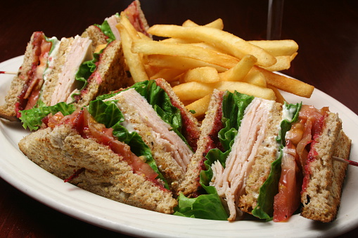 Turkey club sandwich served with French fries.Please see my portfolio for many more food photos.