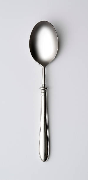 Isolated shot of shiny silver spoon on white background