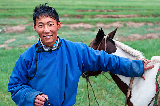 Mongolian horseback rider, hills in the background.http://bem.2be.pl/IS/mongolia_380.jpg