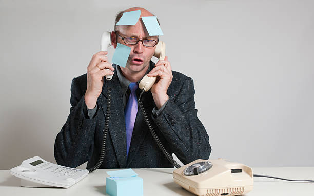 istock Businessman and his two phones 183056916