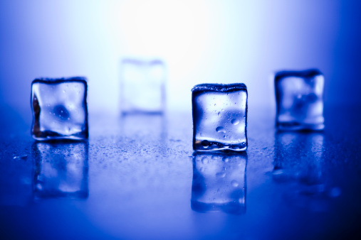 Ice Cubes on blue foreground and high key background.