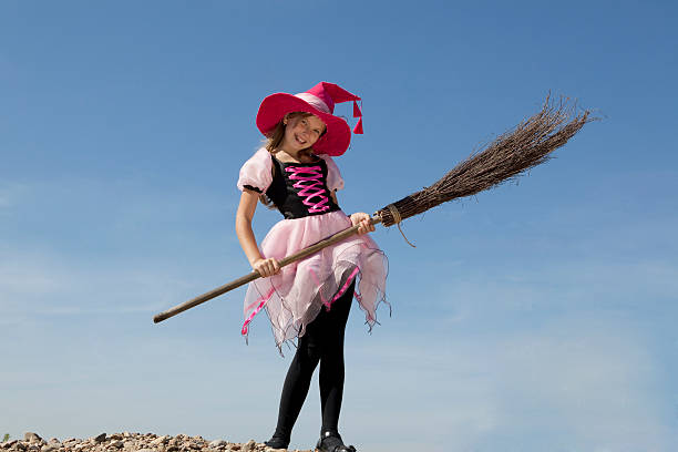 istock Happy Little Witch Standing with a Broom 183057991