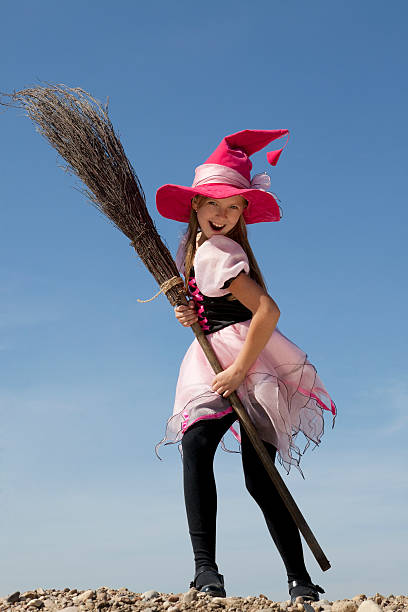 istock Happy Little Witch Standing with a Broom 183057998