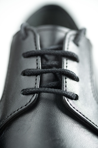 Classic black leather men's shoe laces close-up