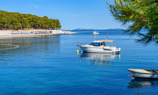 Beach and boats on the Adriatic coast. Primosten, Croatia.