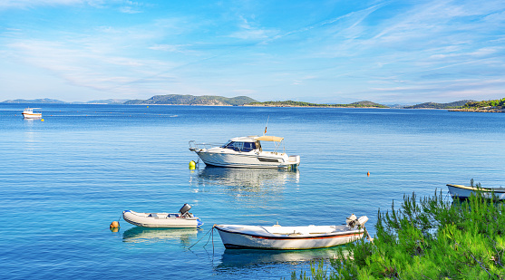Beach and boats on the Adriatic coast. Primosten, Croatia.