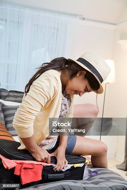 Traveler Struggling With Suitcase In Frustration Vt Stock Photo - Download Image Now