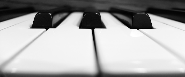 Closeup of piano keys black and white for playing music and entertaining