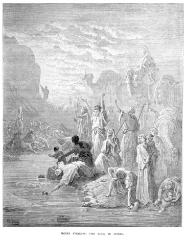 Vintage engraving by Gustave DorA from 1870 showing a scene from the Old Testament Moses striking the rock of Horeb.