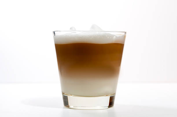 Machiated milk Glass of latte machiato isolated on white. cafe macchiato stock pictures, royalty-free photos & images