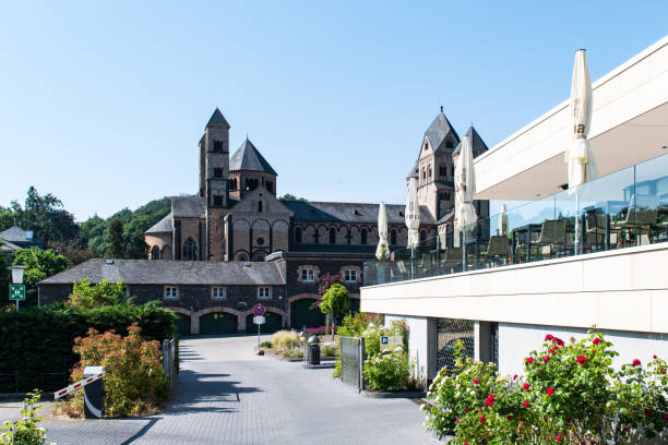 View at the bell towers and the church of the Catholic Maria Laach Abbey near Glees in Germany. The abbey dates back to the year1100 and is now a monastery of the Benedictine Confederation.