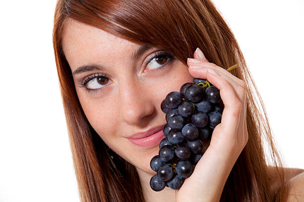 istock Young woman holding fresh grapes 183059415