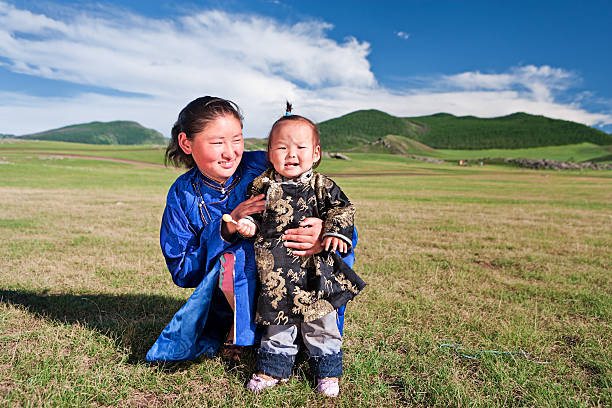 Mongolian mom and baby, lawn and the blue sky in the background.http://bem.2be.pl/IS/mongolia_380.jpg