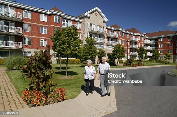 Senior Couple Outdoors Walking Stock Photo - Download Image Now - Senior Adult, House, Building Exterior