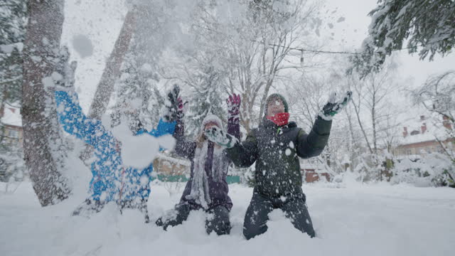 Teenage kids are playing in winter backyard
