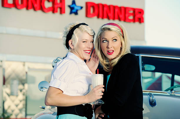 istock Two 50's Women Sharing Exchanging Gossip At The Local  Diner 183059894