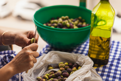 Scratching olives before putting them into the jars.
