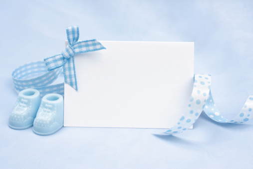 Blank card with a baby boy theme on a blue background.