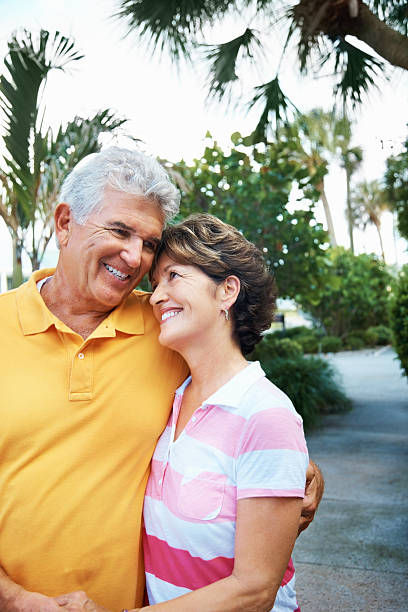 istock Mature couple with arms around smiling at each other 183060209