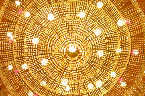 Chandelier and ceiling with lighting close up texture in Indian temple culture and style of art with colorful