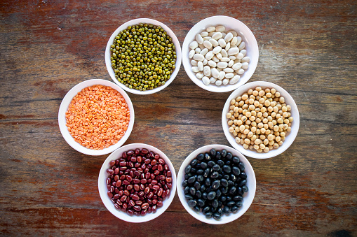 A variety of legume organic protein plants that are beneficial to the body and health on a white plate.