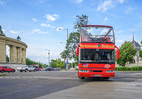 Budapest, Hungary - July 21, 2023: Tourist sightseeing bus on the streets of Budapest, Hungary.