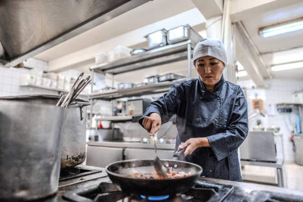 istock Mature woman cooking in a commercial kitchen 1830613832