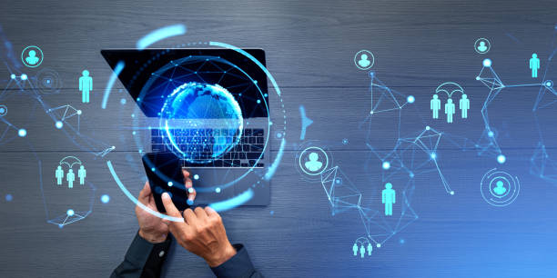 istock Businessman with smartphone and computer, earth sphere and social network icons 1830613885