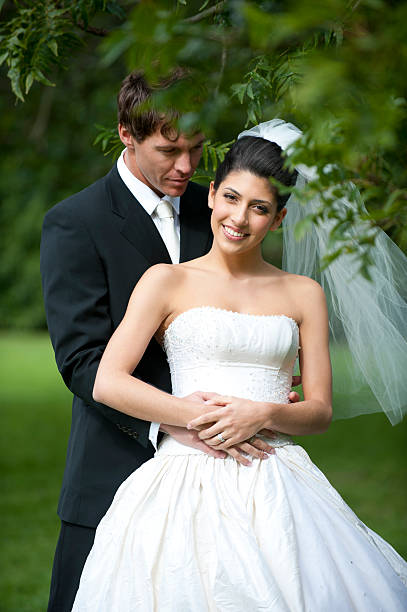 istock Bride and Groom framed by soft focus leaves 183061441