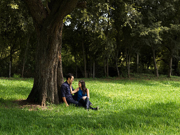 istock Latin couple sitting at the park 183061501