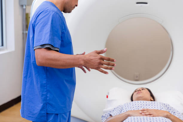 istock Unrecognizable male tech explains scan to woman lying on table 1830615622