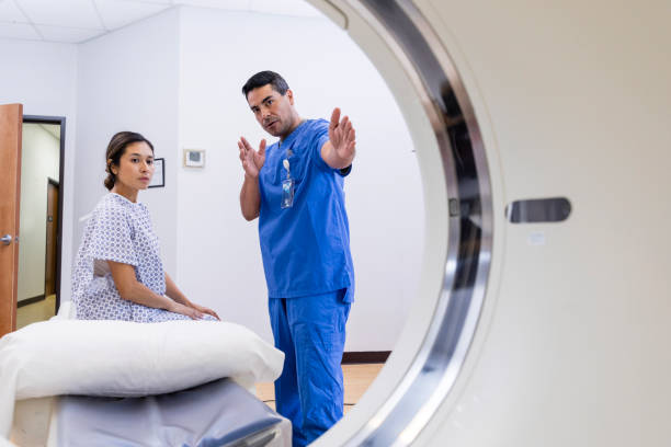 istock View through CT of male technician explaining procedure to woman 1830615638