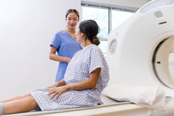 istock Female patient asks CT radiographer questions before scan 1830615652