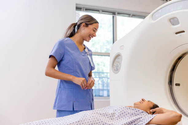 istock Female CT tech and female patient laugh together 1830615653