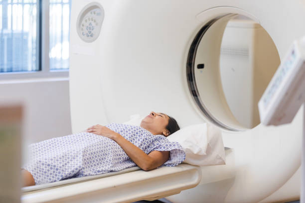 istock Anxious female patient lies on CT table 1830615658