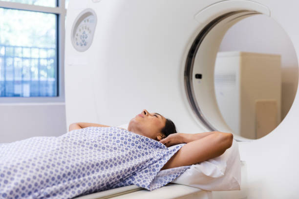 istock Woman lying on CT table waits for scan to start 1830615671