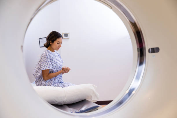 istock View through scanner opening of woman praying before scan 1830615672