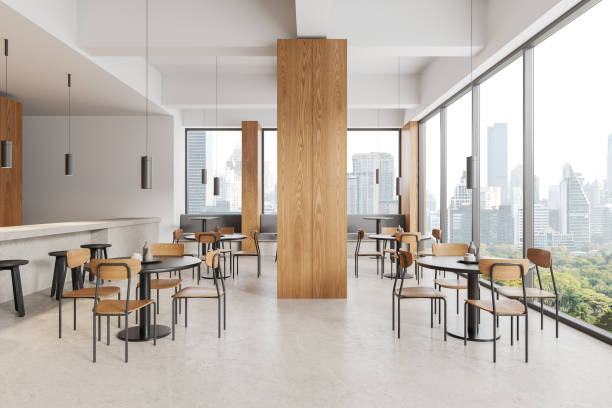 istock Modern cafe interior with chairs and table, counter and panoramic window 1830621157