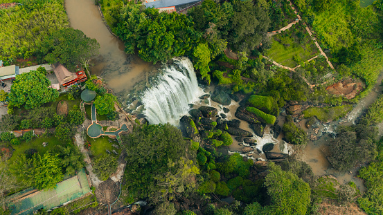 Aerial view of Thac Voi - Elephant waterfall, forest and city scene near Dalat city and Linh An pagoda in Vietnam. Nature and travel concept.