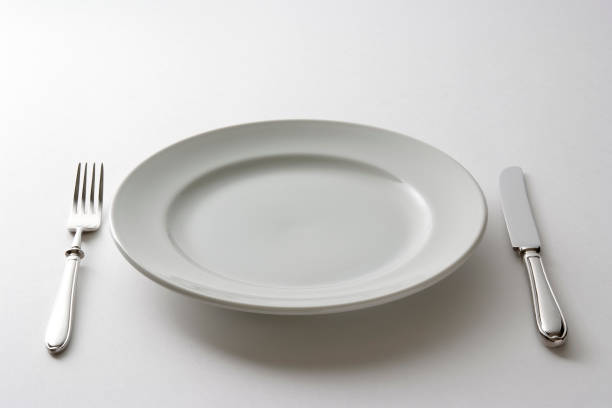 istock Isolated shot of empty plate and cutlery on white background 183062266