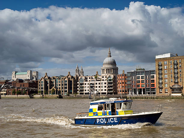 Police boat on the River Thames "Police boat patrolling the Thames, the dome of St Paul's and the Millennium Bridge can be seen in the background." bankside photos stock pictures, royalty-free photos & images