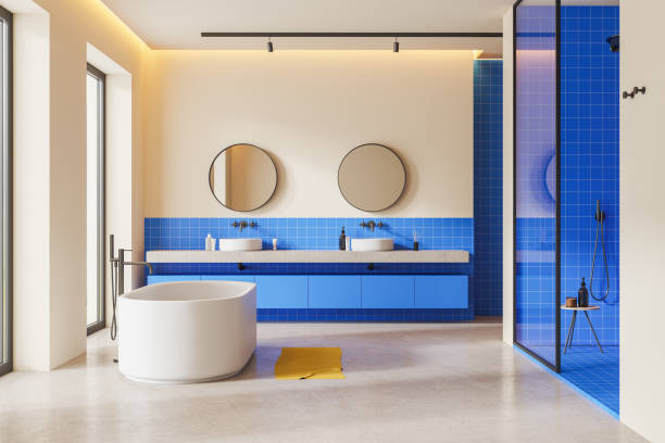 istock White and blue bathroom with tub, sinks and shower 1830626715
