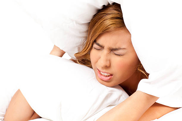 istock Young Woman Frustruated With Pillow On Her Head 183062714