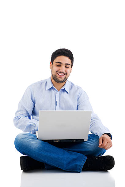 istock Young man sitting on the floor using a laptop 183062925