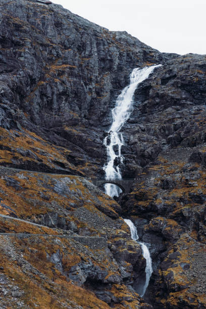 istock Idyllic Waterfall Flowing Under Hairpin Mountain Range at Trollstigen ,Norway 1830631201