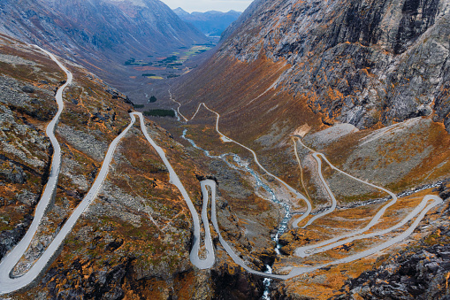 Dramatic high-angle photo of beautiful curvy mountain pass with idyllic view of mountain valley in Western Norway, Scandinavia