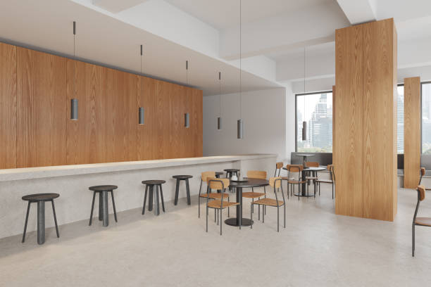 istock Stylish cafe interior with dining table and chairs, bar counter and window 1830634033